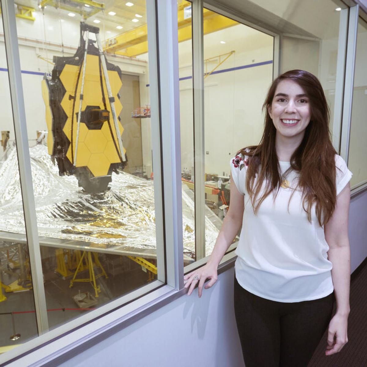 Nathalie Ouellette standing by the JWST