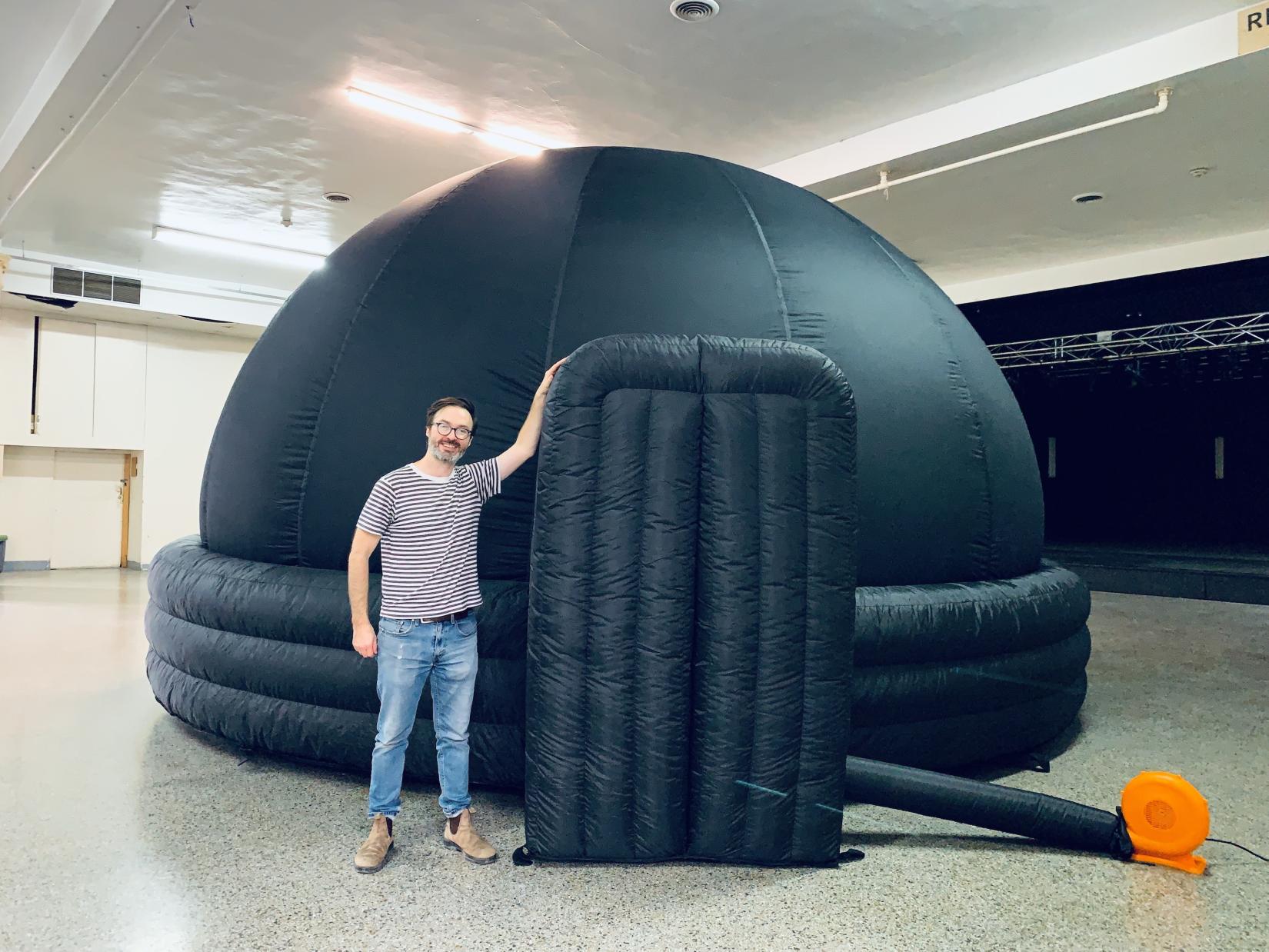 Trevor standing beside dome